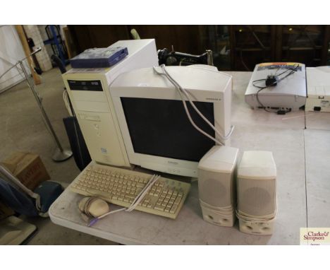 A Philips computer, Mitsubishi monitor, pair of Cambridge computer speaker, keyboard and a mouse