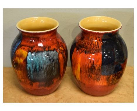Pair of Poole Pottery vases of ovoid form with typical red and orange glaze, 20cm high  