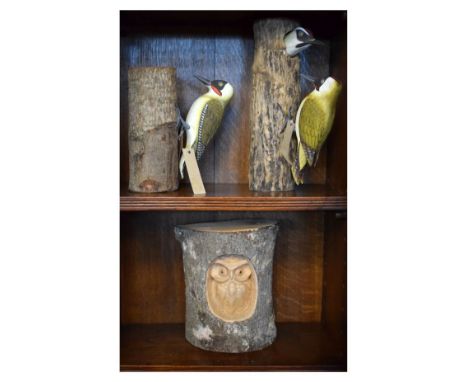 Two carved and painted wooden sculptures of Green Woodpeckers by Beddgelert Woodcraft, together with a third of an Owl in tre