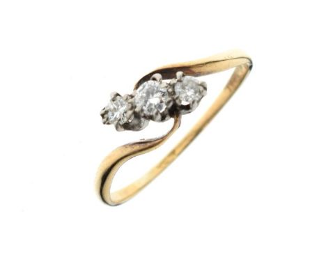 Yellow metal and three stone diamond dress ring of crossover design, shank stamped 9ct, size N, 1.4g gross approx  