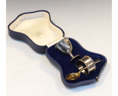 George V silver christening set comprising: egg cup, spoon and napkin ring, Sheffield 1928, 3.2toz approx, in presentation ca
