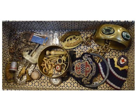 Antique leather miniature dome top trunk enclosing a selection of buckles, chains, bangles, Red Cross regalia etc, the trunk 