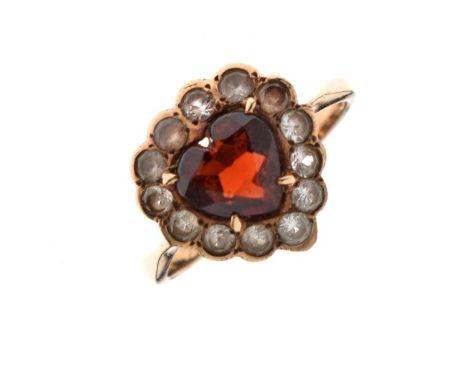 Yellow metal, diamond and red garnet dress ring set central heart-shaped stone within diamond border, shank stamped 9ct, size