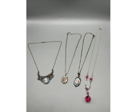 A Lot of four vintage silver ladies necklaces. Includes a Wedgwood cameo and marcasite pendant attached with necklace. 