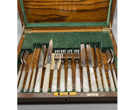 A Silver plate and mother of pearl knife and fork set. Missing one, replaced by a silver and mother of pearl knife. 