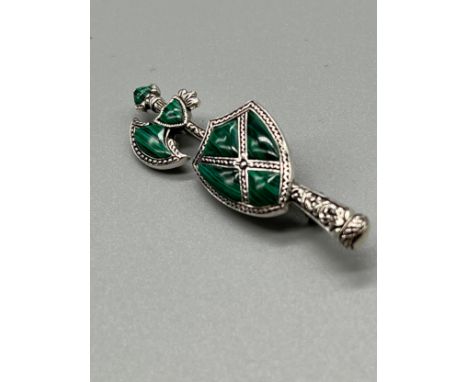 A Silver and Malecite Scottish axe brooch. [5.5cm high] 