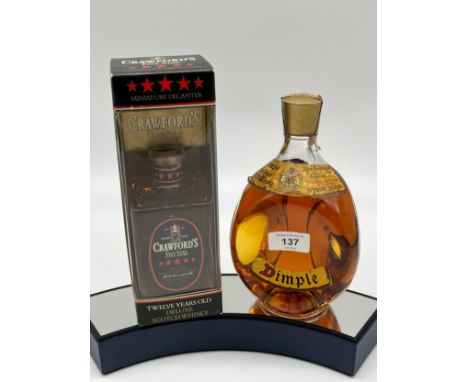 A Vintage bottling of Dimple , 70% proof. Together with a bottling of Crawford's Five Star Scotch Whisky. 