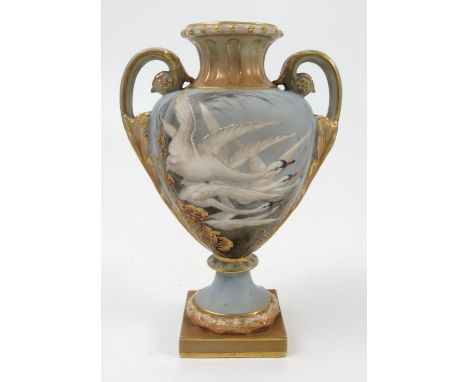 A Royal Worcester twin handled vase, decorated with five swans in flight to powder blue ground with gilt foliage, decorated w