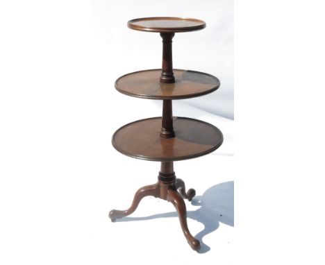 A Georgian mahogany dumb waiter, raised on a tripod base terminating in three pad feet