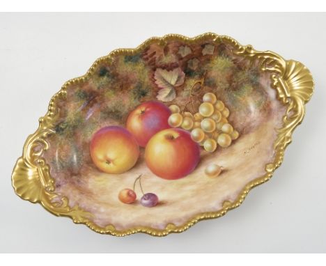 A Royal Worcester oval dish, hand painted with fruit to a mossy background by H Ayrton, with shaped gilt edge, maximum diamet