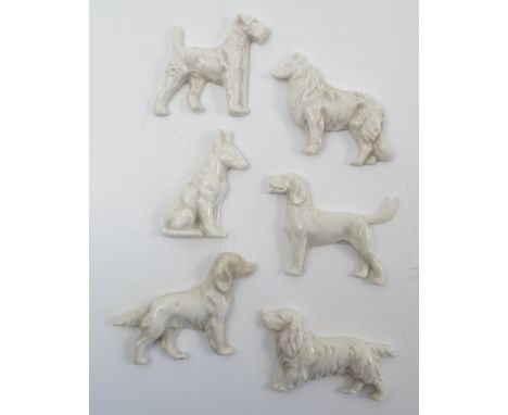 A group of un-marked Royal Worcester porcelain dog brooches, all blank, some being duplicates, 21 in total