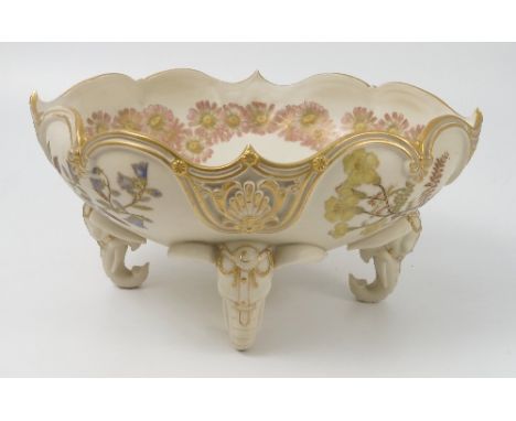 A Royal Worcester gilded ivory centre piece, of shaped oval form, decorated in shot silk colours with flowers, raised on four