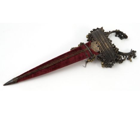 An Eastern push dagger, in gilt metal, with curved ribbed knuckle guard and chains to a hinged bangle, decorated with bells, 