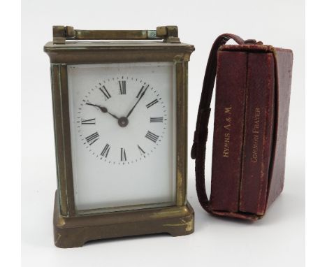 A carriage clock, with white enamel dial and Roman numeral, height including handle 5.5ins, together with a leather covered c