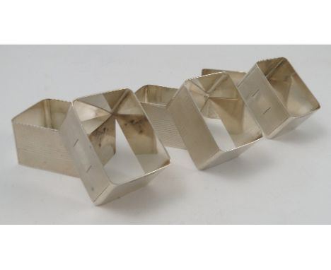 A set of six silver napkin rings, of rectangular form, with engine turned decoration,  Birmingham 1944, maker Harmen Brothers