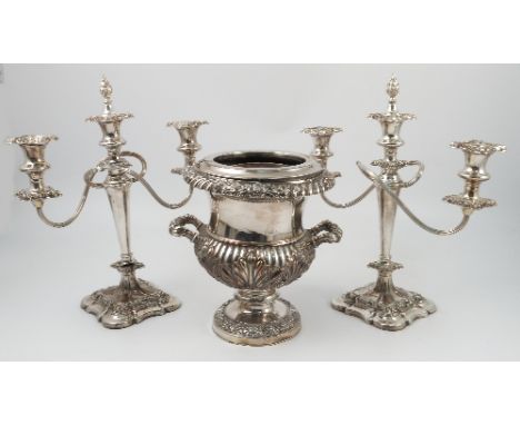 A silver plated campana shaped urn, with flower, leaf and gadrooned decoration, raised on a circular pedestal foot, height 10