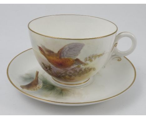 A Royal Worcester oversize cup and saucer, the cup decorated with a grouse in flight over foliage, signed Price?, the saucer 