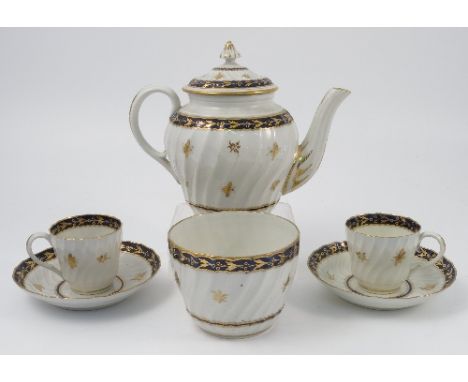 A Worcester porcelain part tea service, decorated with bands of blue and gilt with wrythen moulded body and gilt flowers and 