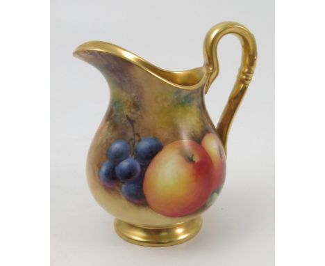 A Royal Worcester jug, hand painted with fruit to a mossy background by J Smith, with gilt interior, height 4ins