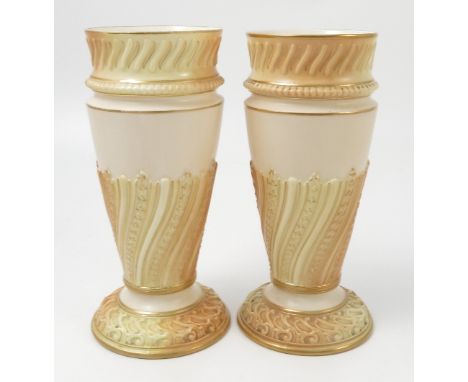 A pair of Royal Worcester gilded and blush ivory vases, the tapering body with wrythen moulded decoration, shape number 1545,