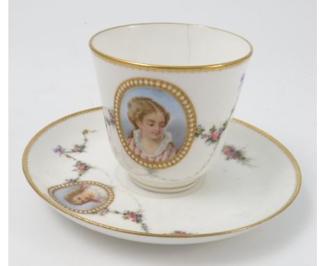 A Royal Worcester cup and saucer, decorated with garlands of flowers to a white ground with a reserve portrait of a young gir