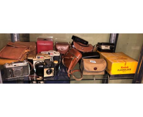 SHELF OF VARIOUS KODAK CAMERAS INCLUDING BROWNIE 127, BROWNIE CRESTA 3, BROWNIE VECTA, JUNIOR 620, INSTAMATIC, TYPE B FLASH H