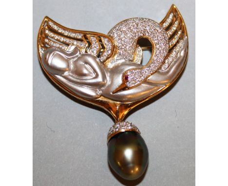 A SUPERB ART DECO BROOCH formed as a swan and reclining young lady set with diamonds with a diamond mounted pearl acorn drop.