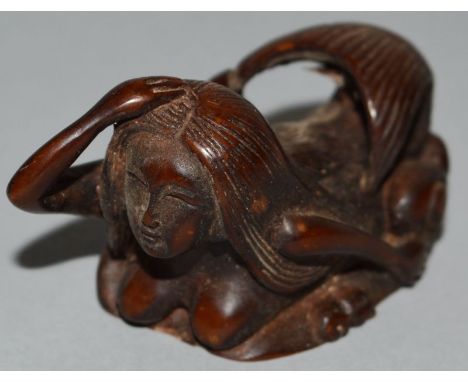 A CARVED WOOD NETSUKE, a mermaid. 