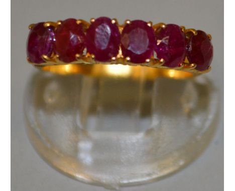 A GOOD SIX STONE RUBY HALF HOOP RING set in 20ct gold. 