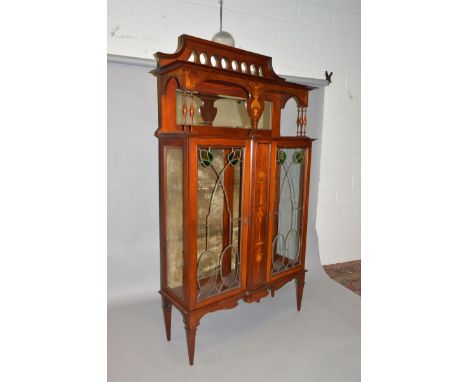 A LIBERTY & CO MAHOGANY INLAID CHINA CABINET, the top with pierced frieze, mirror back and turned column supports over double