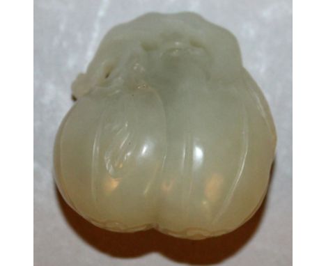 A CHINESE CELADON-GREEN JADE-LIKE MODEL OF FRUIT, 1.5in high. 