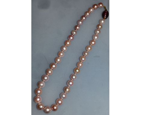 A FRESHWATER PEARL NECKLACE with amethyst gold clasp. 