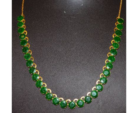 A 20ct GOLD AND JADE SET NECKLACE. 