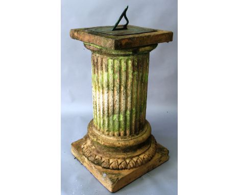 AN ENGRAVED BRASS SUNDIAL supported on a terracotta base of classical column form. 2ft 6ins high. 