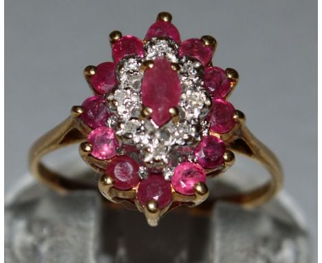 A RUBY AND DIAMOND CLUSTER RING set in 9ct yellow gold. 