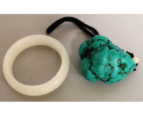 A CHINESE WHITE JADE-LIKE BANGLE, along with a turquoise stone boulder. The bangle 3.2in diameter and the boulder 2.6in long.