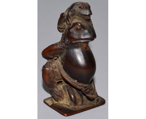 A CARVED WOOD NETSUKE, a strange animal and a frog. 