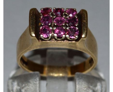 A RUBY AND DIAMOND RING set in 9ct yellow gold. 