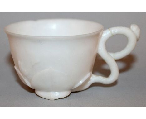 AN UNUSUAL CHINESE WHITE JADE-LIKE CUP, it’s base formed with lotus leaves, it’s handle with a lotus tendril, 2.3in diameter 