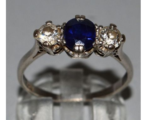 A SAPPHIRE AND DIAMOND THREE STONE HALF HOOP RING set in 18ct white gold, centre sapphire and two diamonds. 