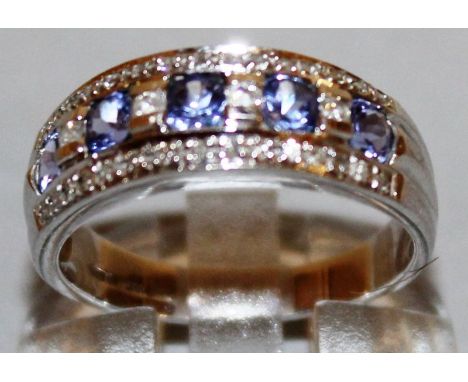 A WHITE GOLD AND TANZANITE RING. 