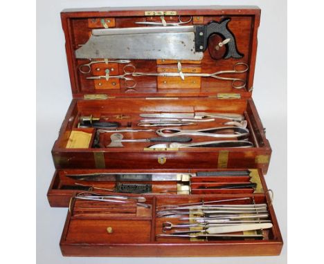 A FULL SURGEONS KIT IN A FITTED WOODEN BOX, belonging to Sydney W. Thompstone F.R.C.S.E., in a brass bound mahogany case, thr