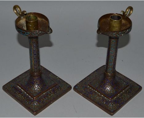 A GOOD PAIR OF COPPER AND BLUE ENAMEL CANDLESTICKS formed as oil lamps on square bases. 8ins high. 