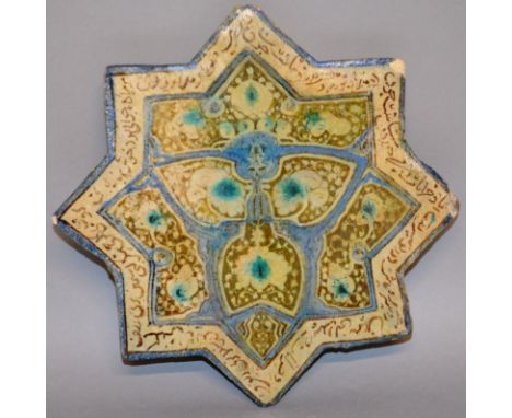 AN ISLAMIC TILE, of star shape, the border decorated with calligraphy. 8ins diameter. 