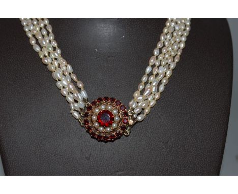 A FIVE ROW SEED PEARL NECKLACE with gold circular AMETHYST AND SEED PEARL CLASP. 
