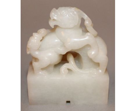 A SMALL CHINESE WHITE JADE-LIKE SEAL, in the form of two battling chilong, the base 1.6in x 0.75in & 1.9in high. 