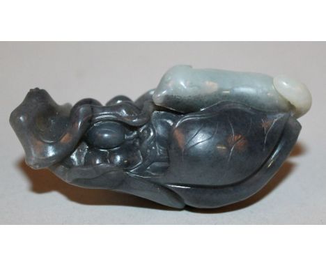 A CHINESE WHITE & GREY JADE LIKE MODEL OF A RAT, on leaf-shrouded grapes, 2.75in long. 