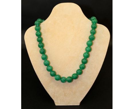 A CHINESE GREEN JADE-LIKE NECKLACE, composed of spherical beads, approx. 22.5in long. 