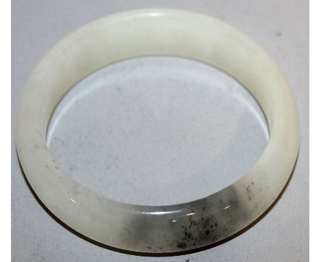 A CHINESE WHITE JADE BANGLE, 2.7in diameter. 