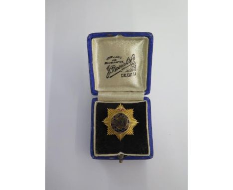 A 9ct yellow gold and enamel Royal Indian Army Service Corps badge - Width 31mm - approx weight 10 grams - with original box,